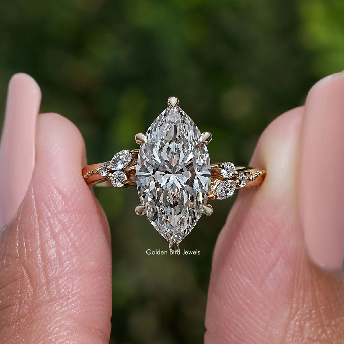 Marquise-cut center stone ring with halo and small round side stones