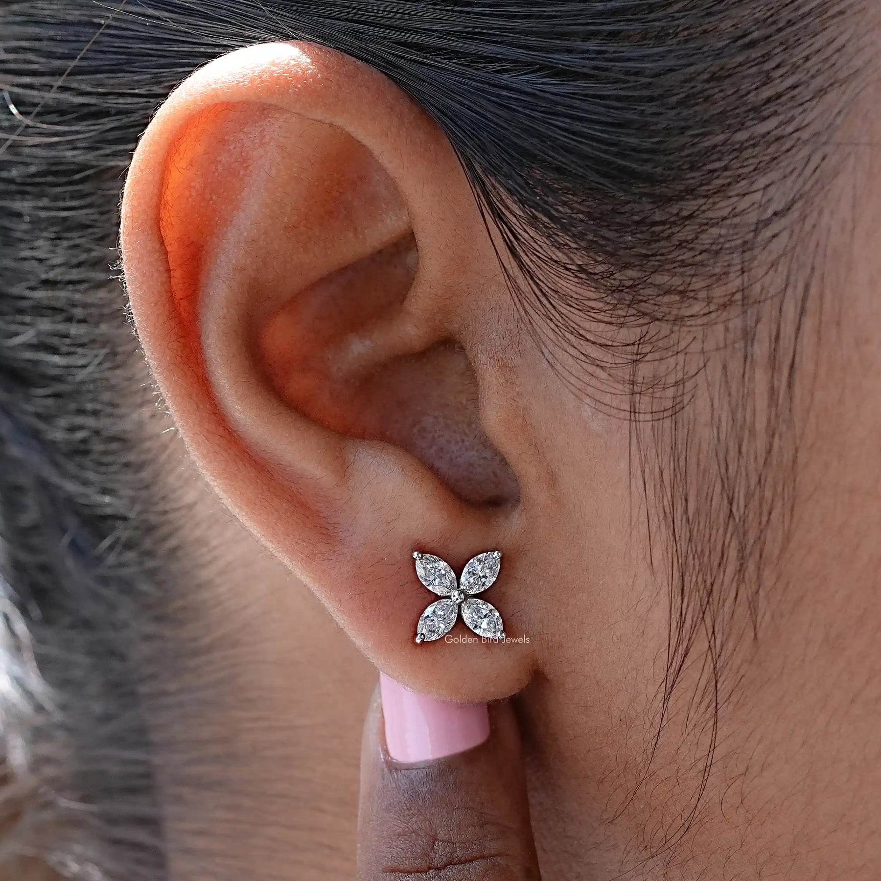 In ear close view of marquise cut lab diamond engagement ring 