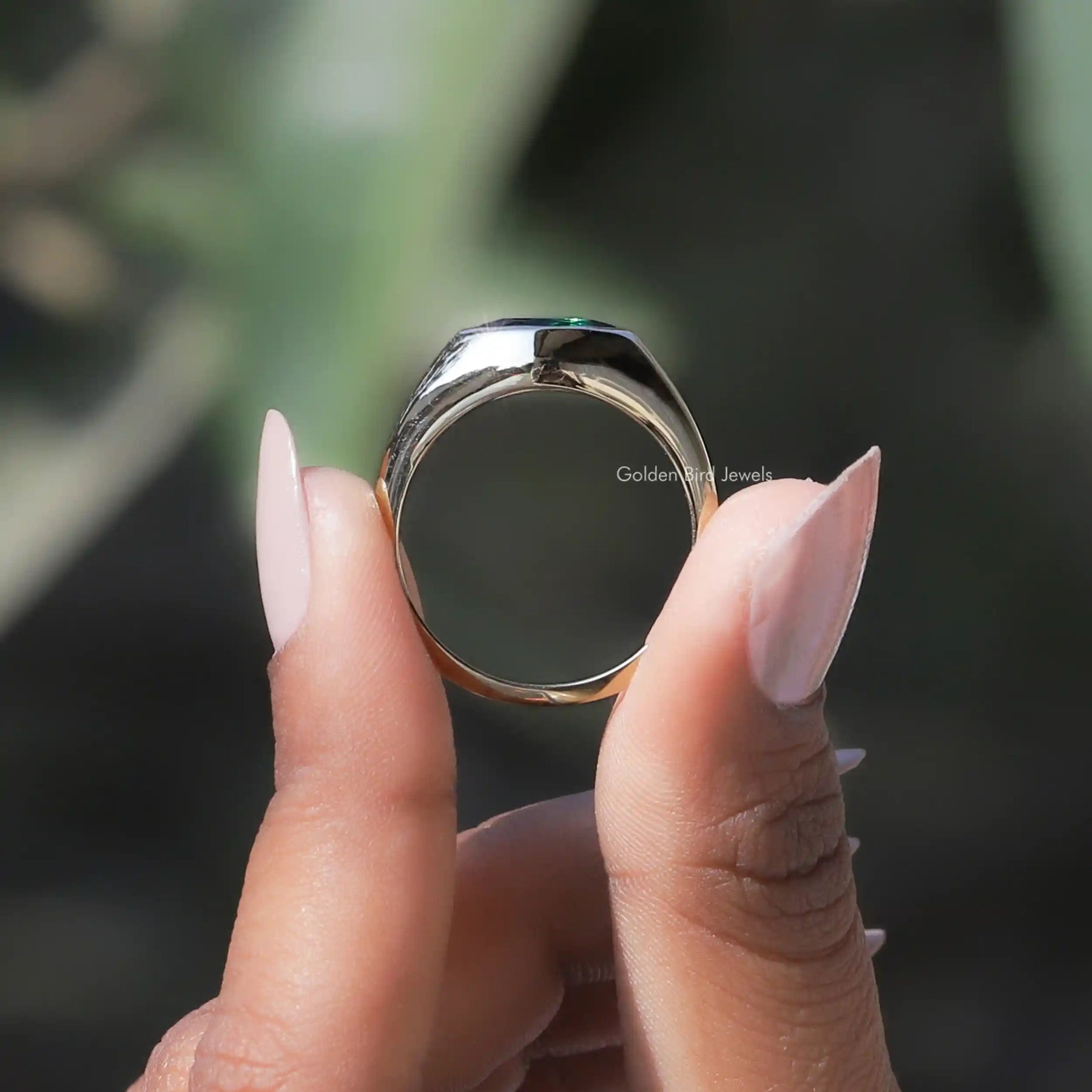 Back View of Moissanite Marquise Bezel Set Ring In two fingers
