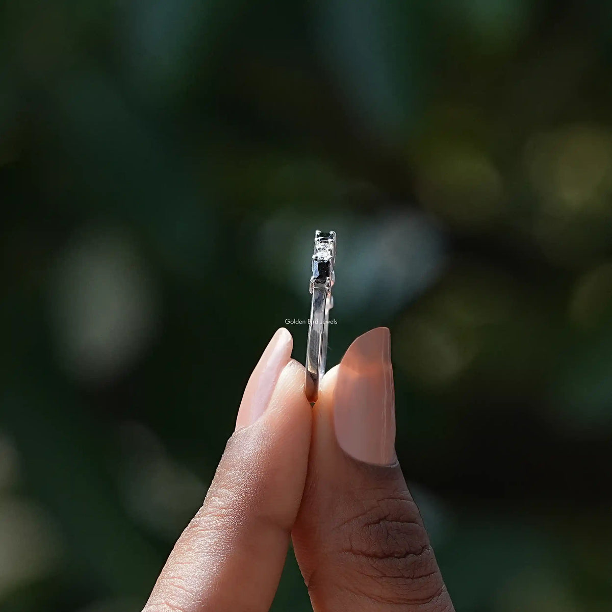 Side View of Black Baguette Cut Moissanite Wedding Band In two fingers