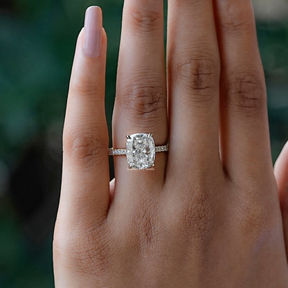 In finger front view of halo cushion moissanite engagement ring 