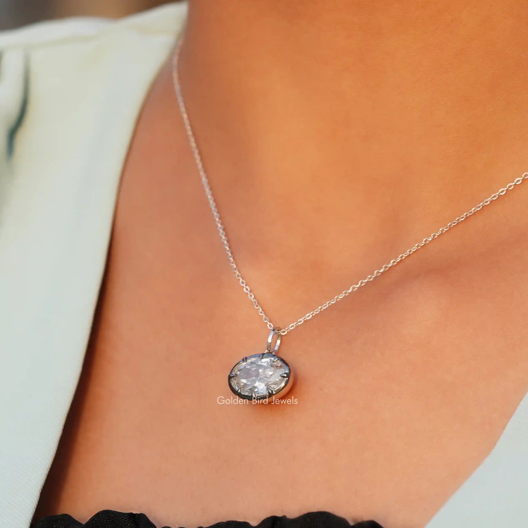 In neck view of east-west crushed moissanite halo pendant 
