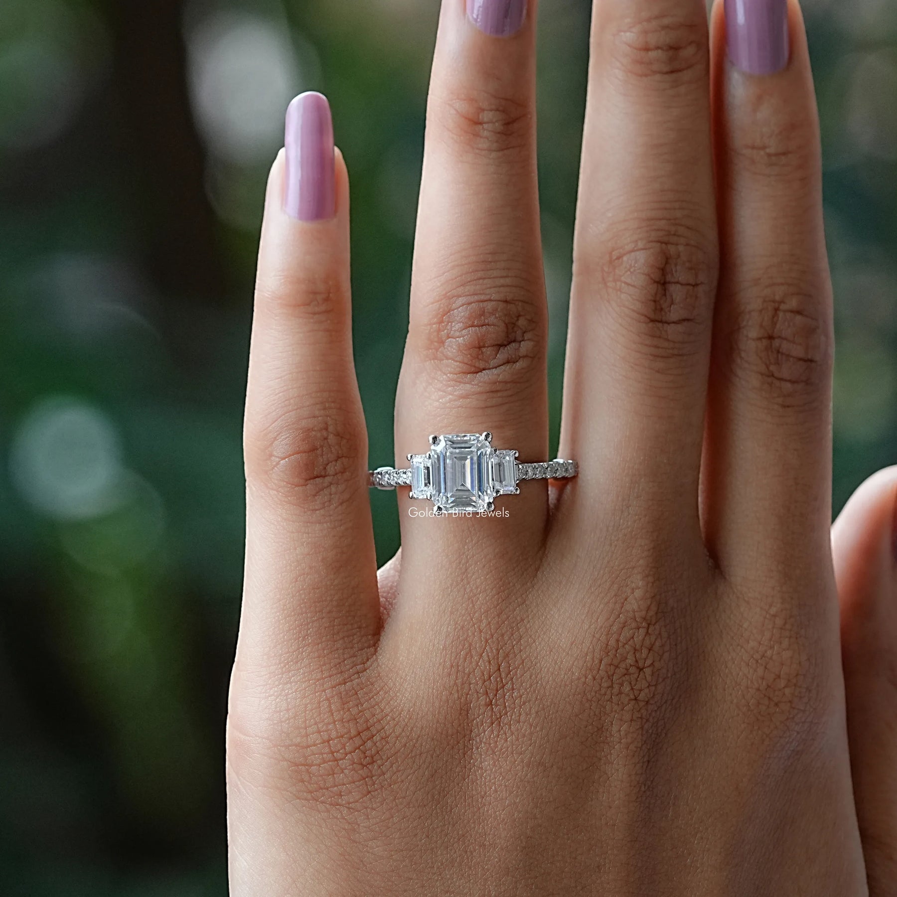 View of Emerald Cut Three Stone Engagement Ring In White Gold