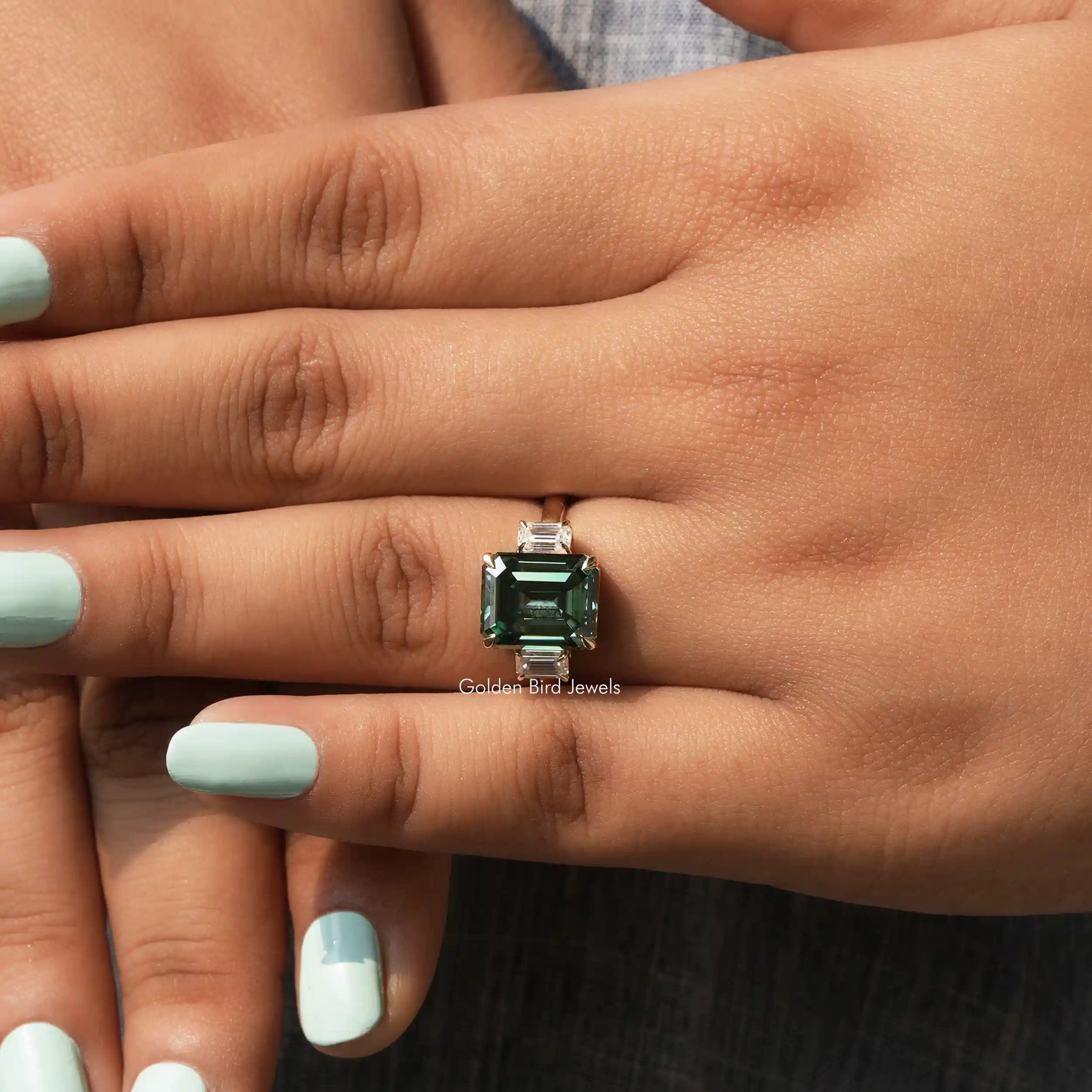View of Three Stone Emerald Cut Ring In finger