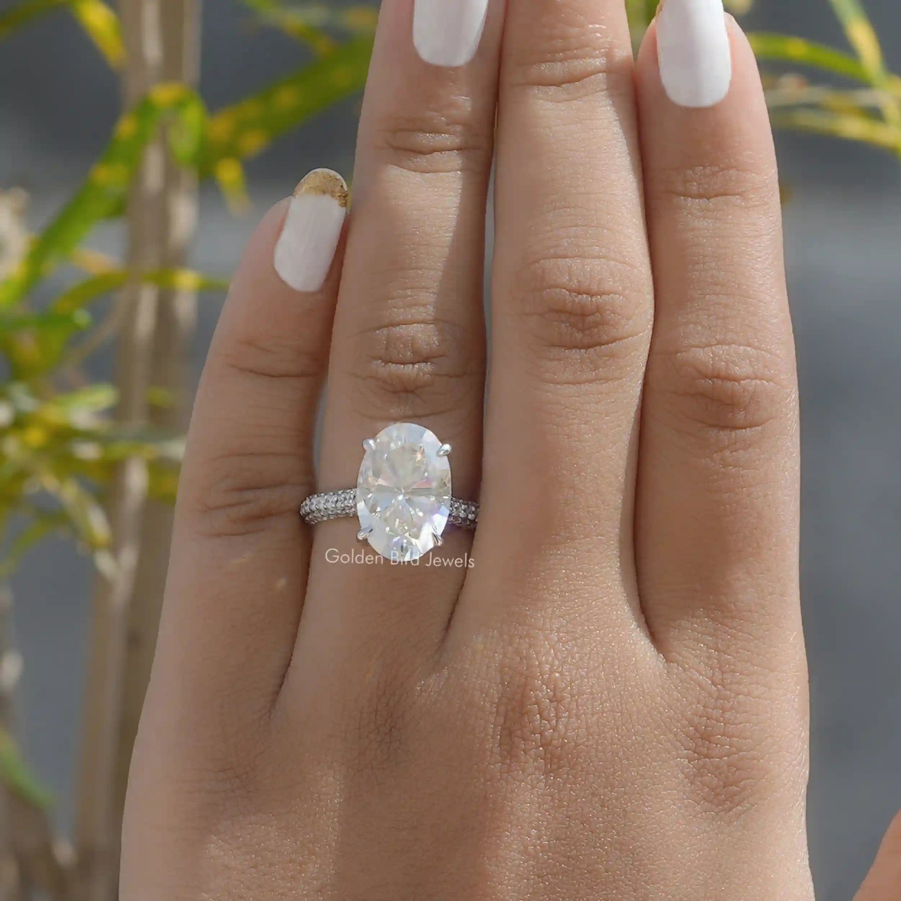 View of Hidden Halo Oval Cut Engagement Ring In Finger