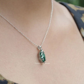 Side view of green marquise pendant In white Gold