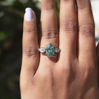 View of Old Mine Pear Cut 3 Stone Ring In finger