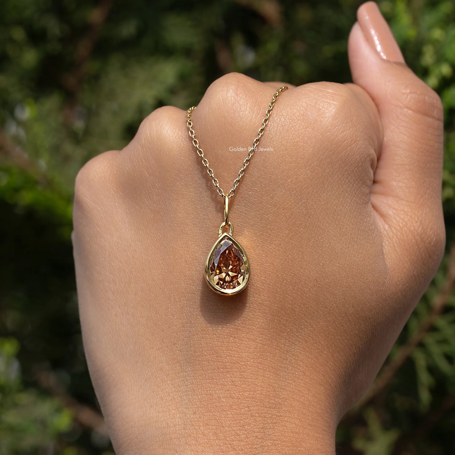 In hand Showing View Of Old Mine Pear Moissanite Pendant 
