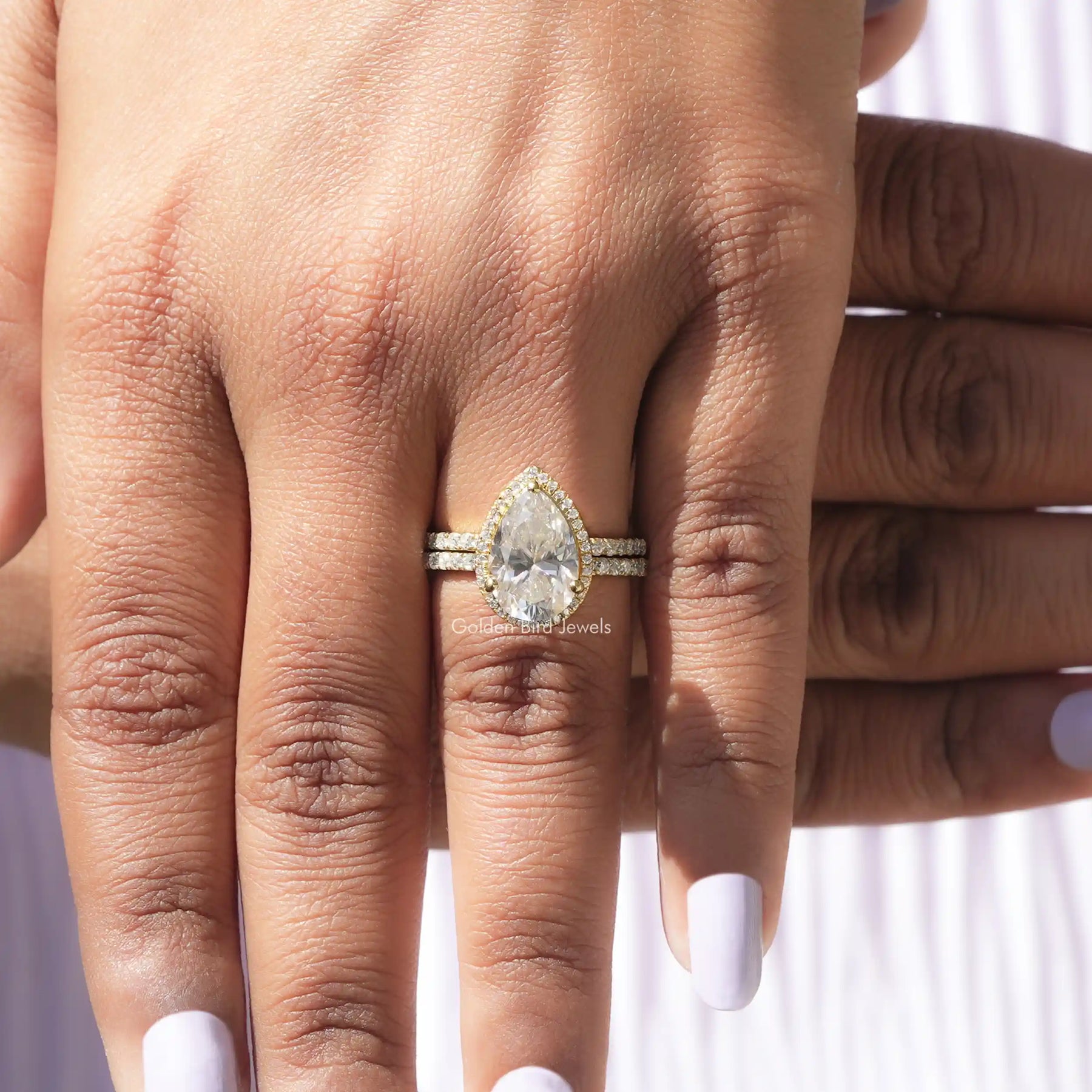 Detailed View Of Pear Cut Moissanite Engagement Ring In Yellow Gold
