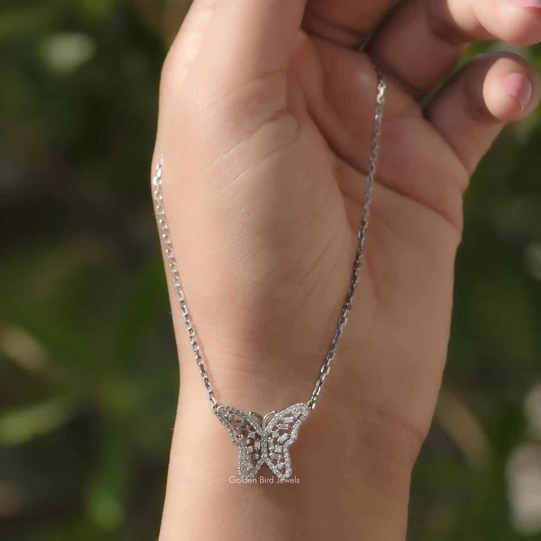 In hand showing view of moissanite pendant	 		