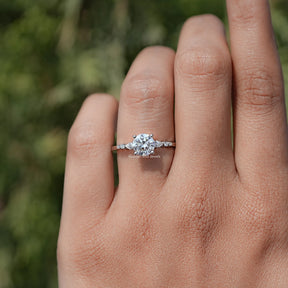 In finger view of Round Cut Moissanite Accent Set Engagement Ring