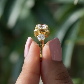 Side View of Three Stone Cushion Cut Moissanite Ring In two fingers