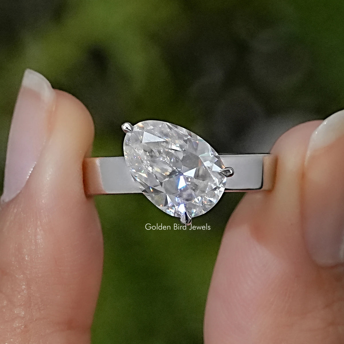 925 sterling silver solitaire ring with a large pear-cut moissanite stone