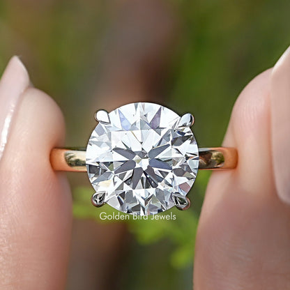Round Cut Lab Grown Diamond Solitaire Ring Held Between Fingers