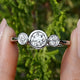 Old European Round Lab Diamond Three Stone Ring Held Between Fingers