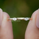 Marquise Cut Lab Diamond Open Cuff Two Stone Ring Held Between Fingers