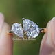 Pear Shaped Lab Diamond Two Stone Ring Held Between Fingers