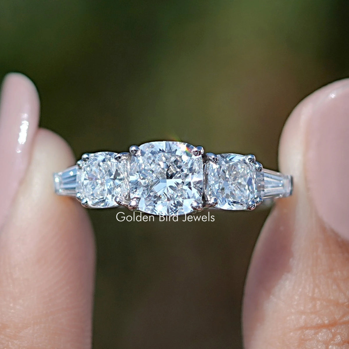 Square Cushion Lab Diamond Five Stone Ring Held  Between Fingers