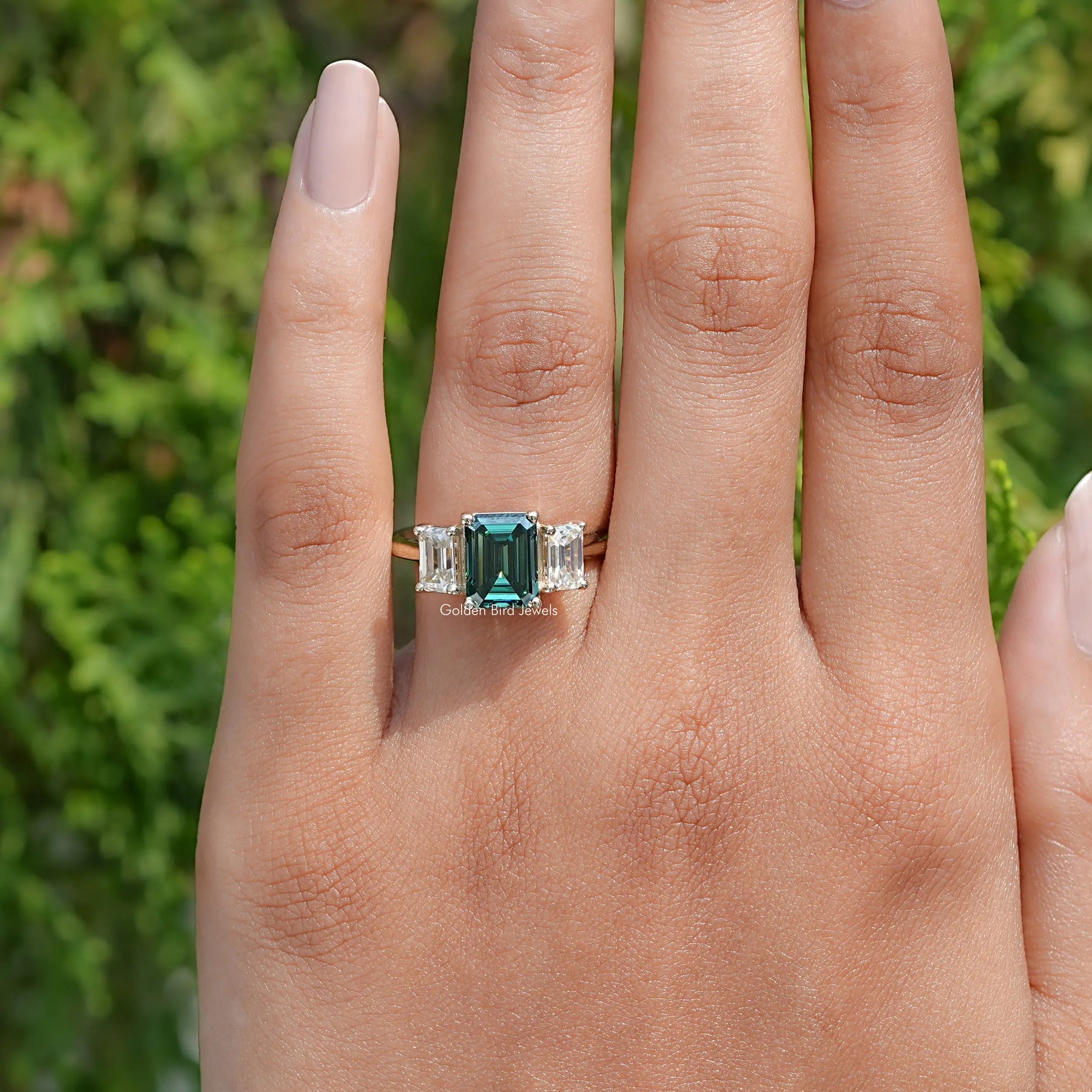 Top View Of Emerald Moissanite 3 Stone engagement ring in prongs setting 