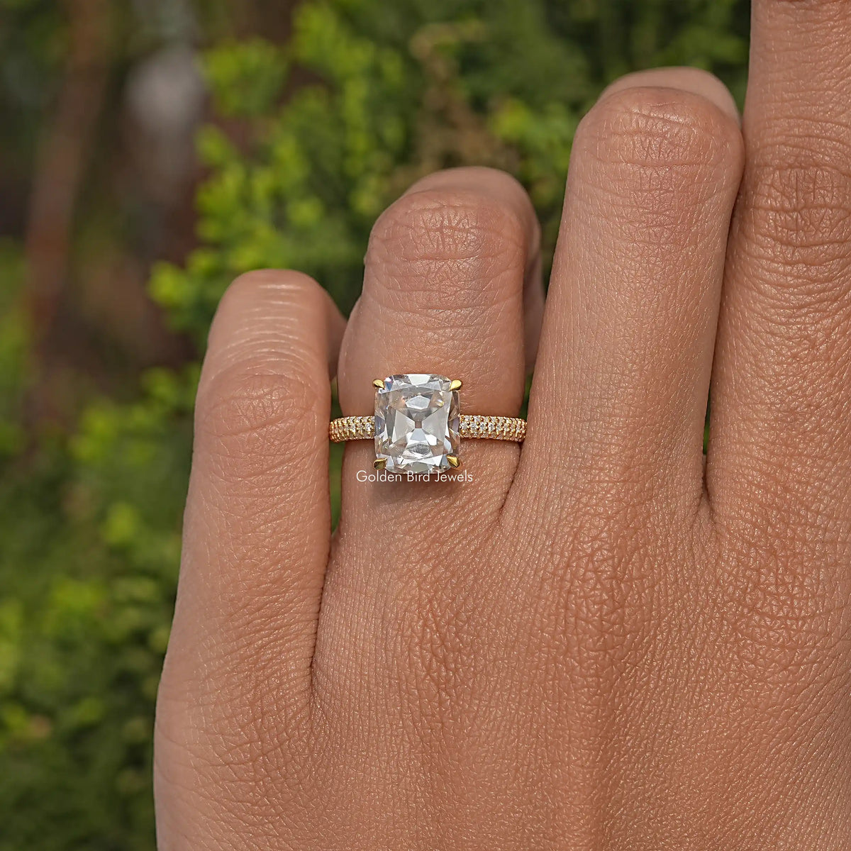 Gold-tone cushion-cut moissanite solitaire engagement ring with pave band