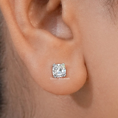Cushion-cut moissanite stud earring with a bright faceted stone, worn on an earlobe
