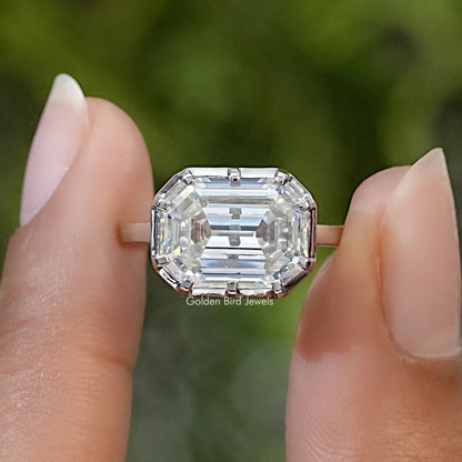 Sterling silver solitaire ring with a large clear emerald-cut stone set east-west