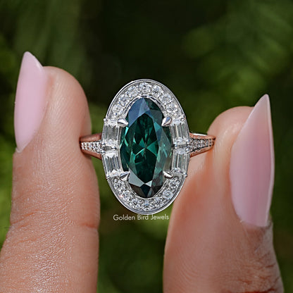Halo ring with dark green oval center gemstone and sparkling silver side accents