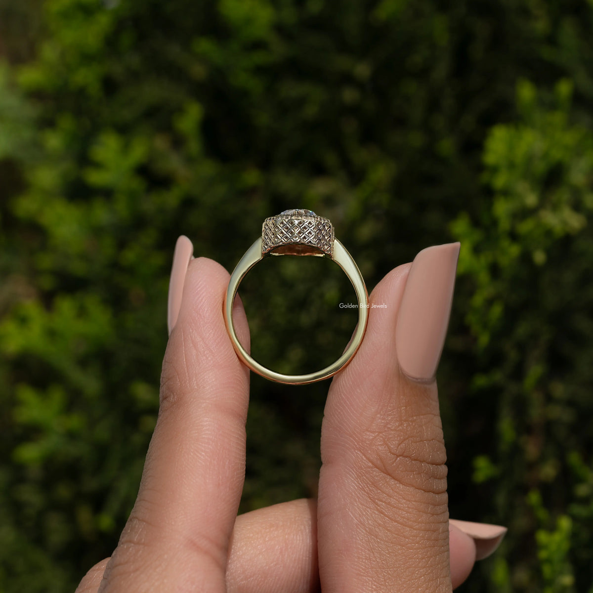 Back view of pear-shaped moissanite solitaire ring, smooth gold-tone band and pave top