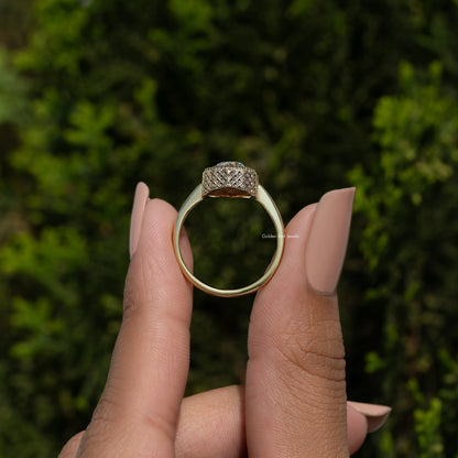 Back view of pear-shaped moissanite solitaire ring, smooth gold-tone band and pave top