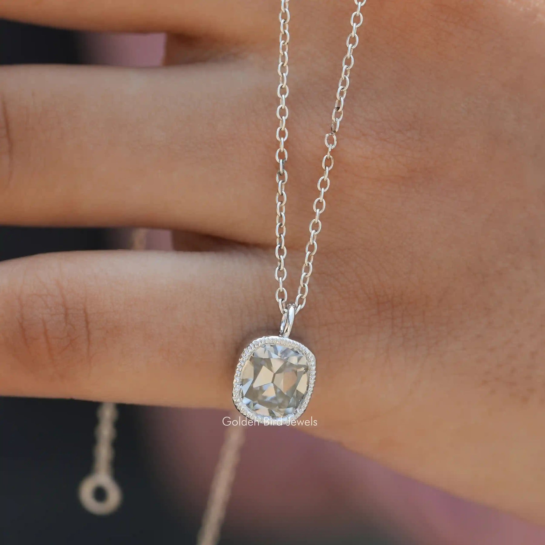 In hand showing view of moissanite pendant	 		