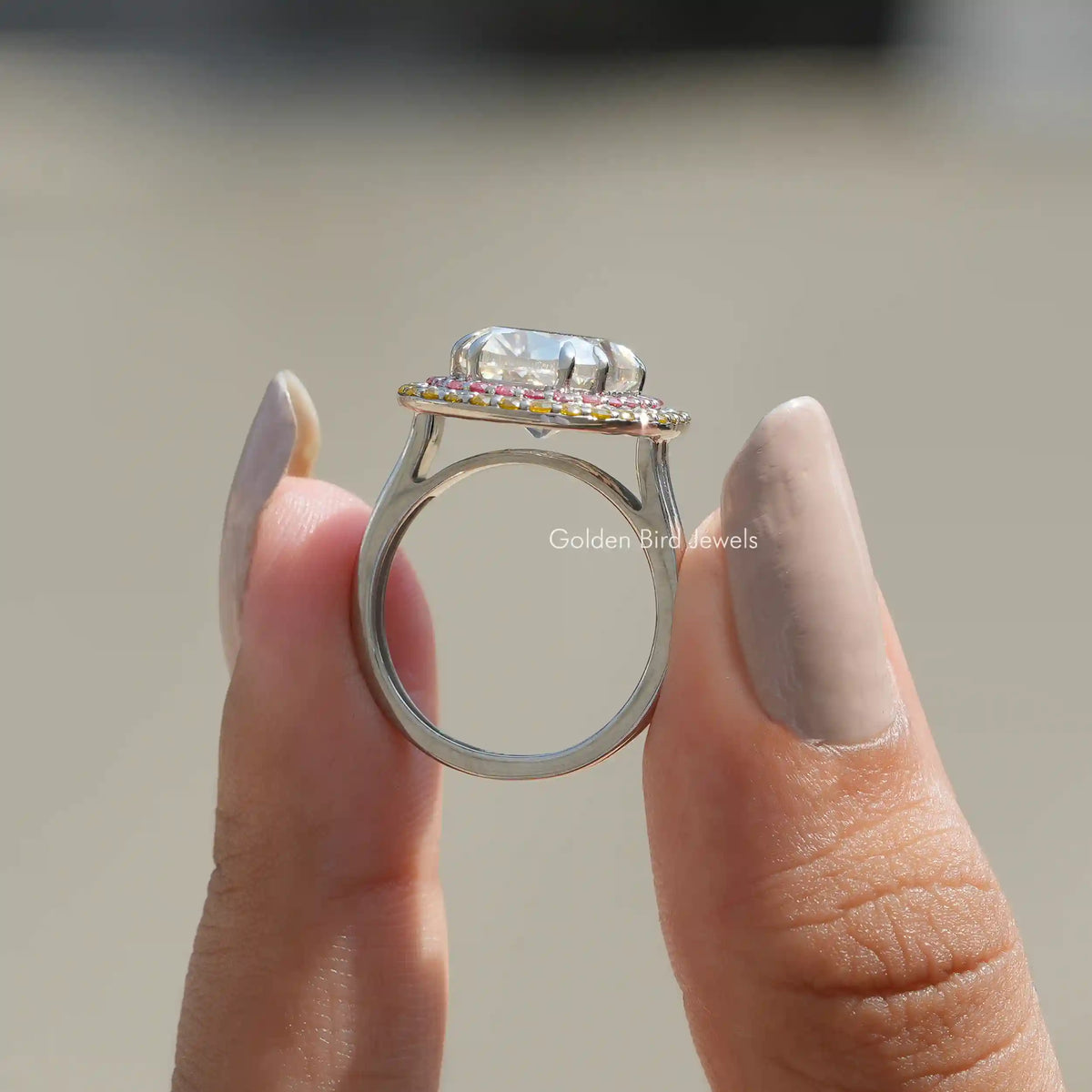 Back View of Cushion Cut Moissanite Engagement Ring In two fingers