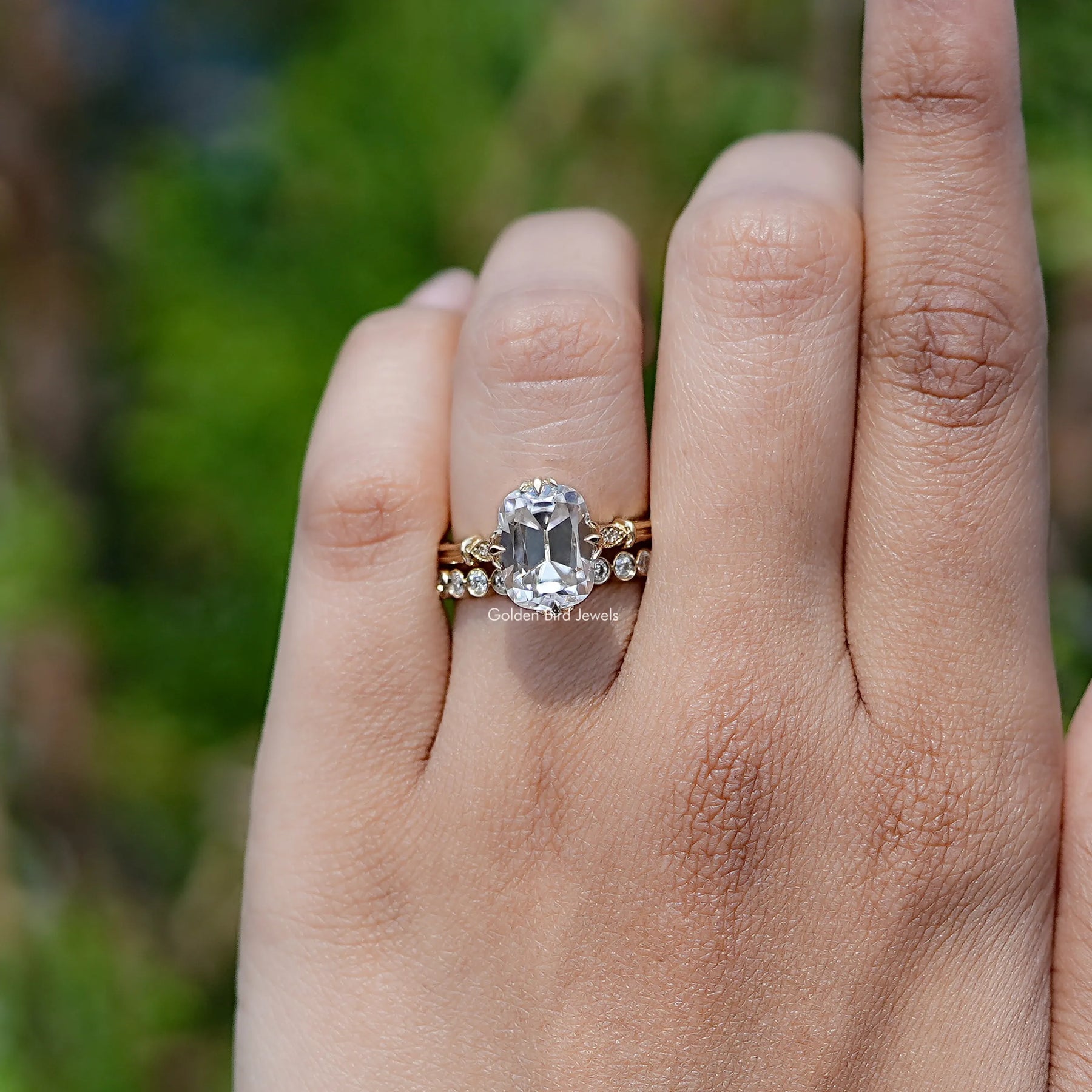 In finger front view of Old Mine Cushion Moissanite engagement ring 