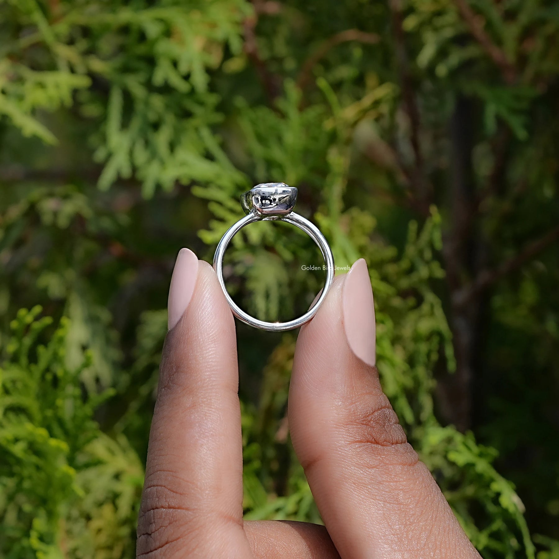 In hand showing view of moissanite Ring	 		
