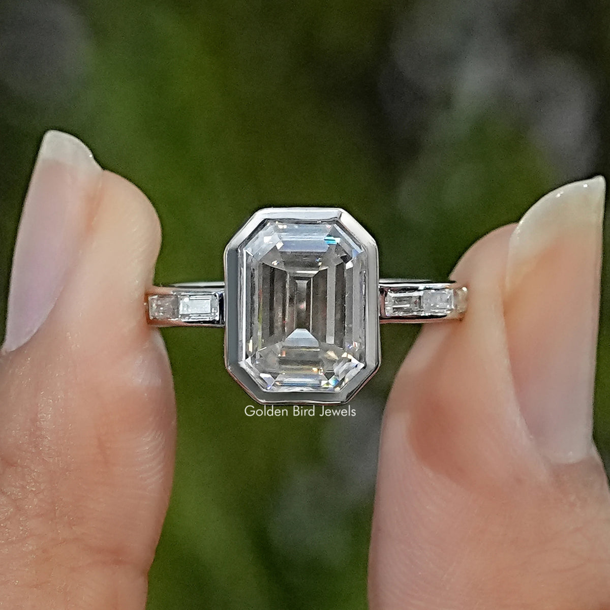 Sterling silver solitaire ring with an emerald-cut center stone and rectangular shoulder accents