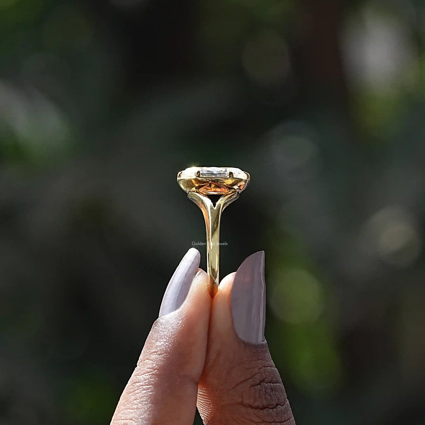 Side View of Old Mine Moval Cut Moissanite Ring In two fingers