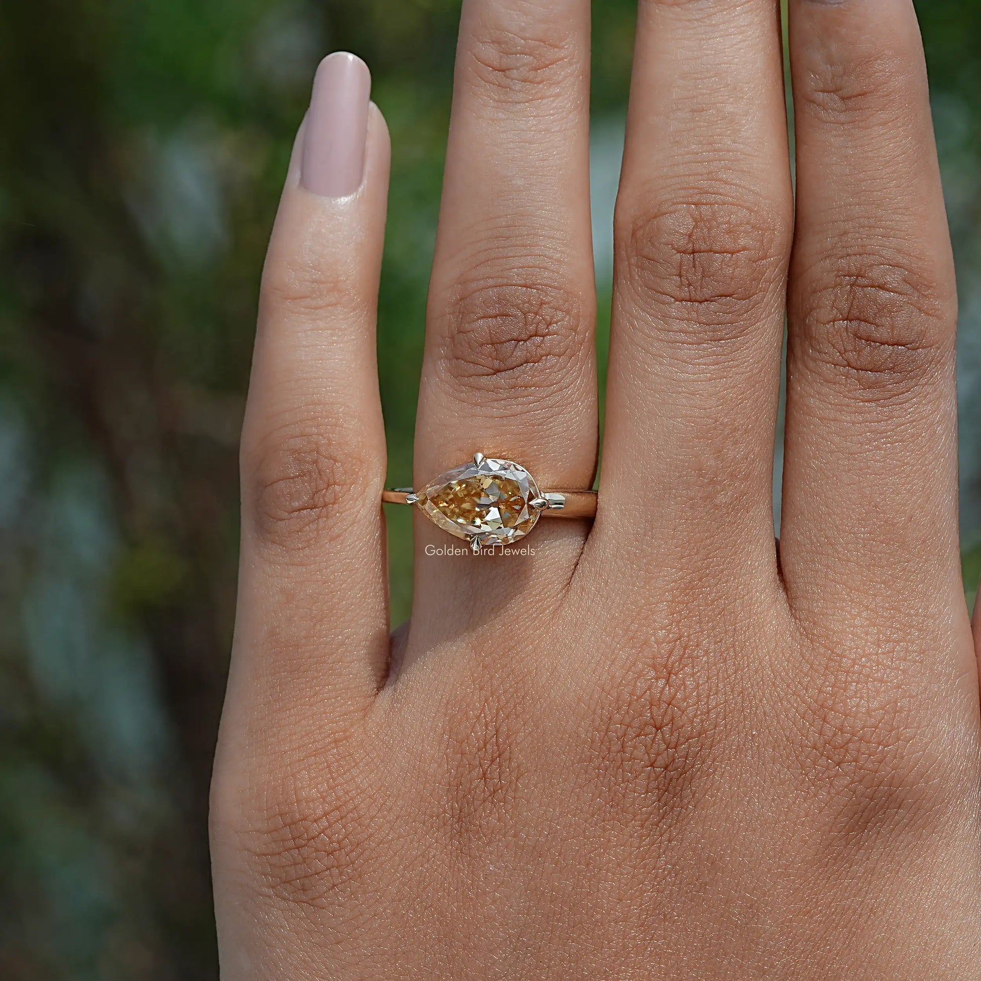 Close-Up View of  Pear Cut Moissanite Engagement Ring In Yellow Gold