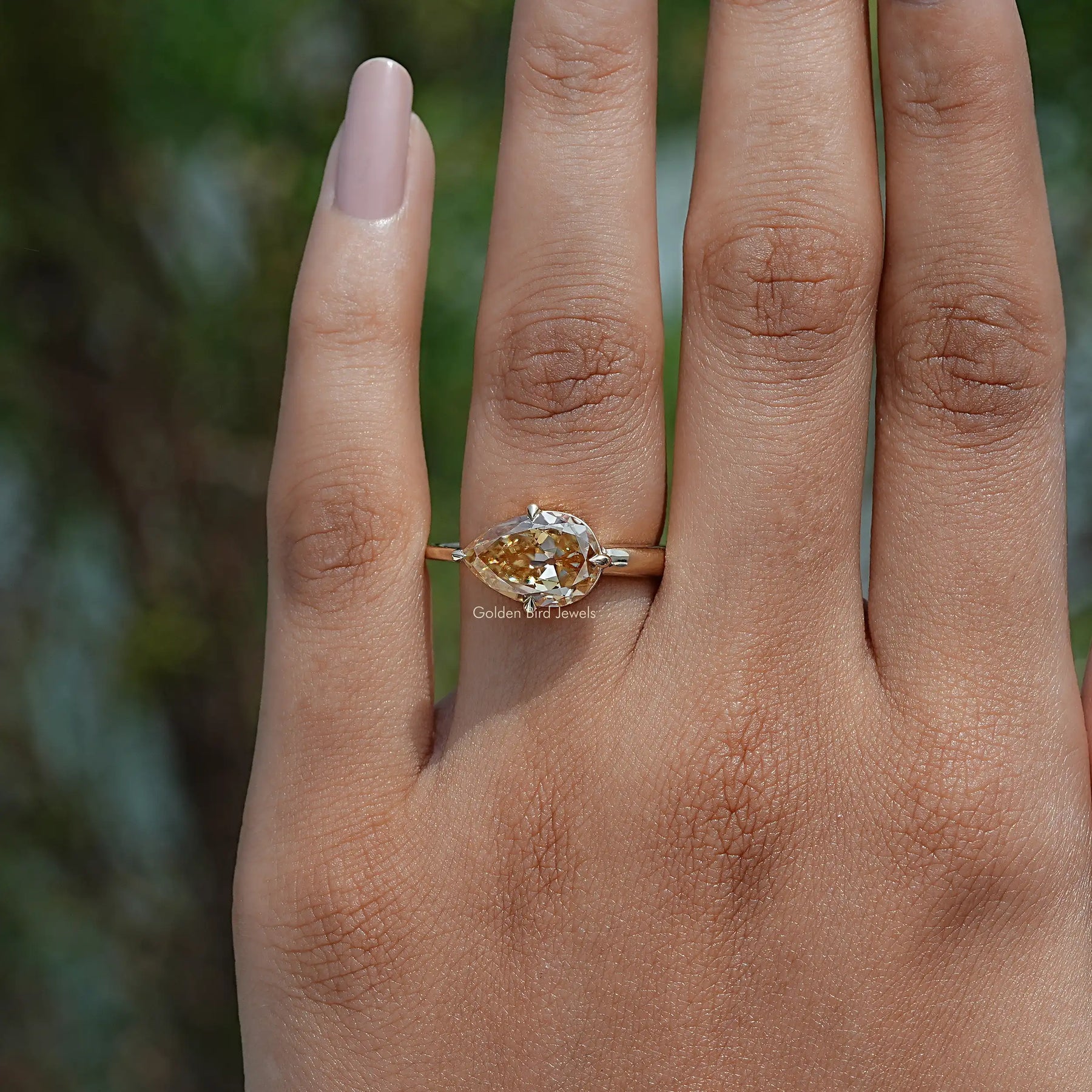 Close-Up View of  Pear Cut Moissanite Engagement Ring In Yellow Gold