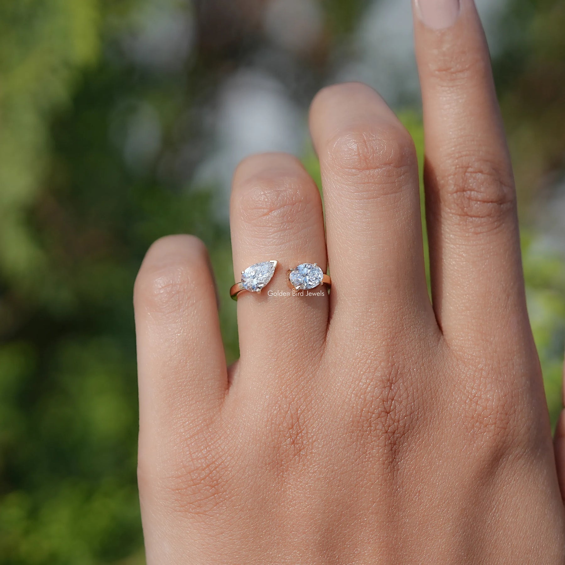 In finger view of Pear And Oval Shape Lab Diamond Halo Ring

