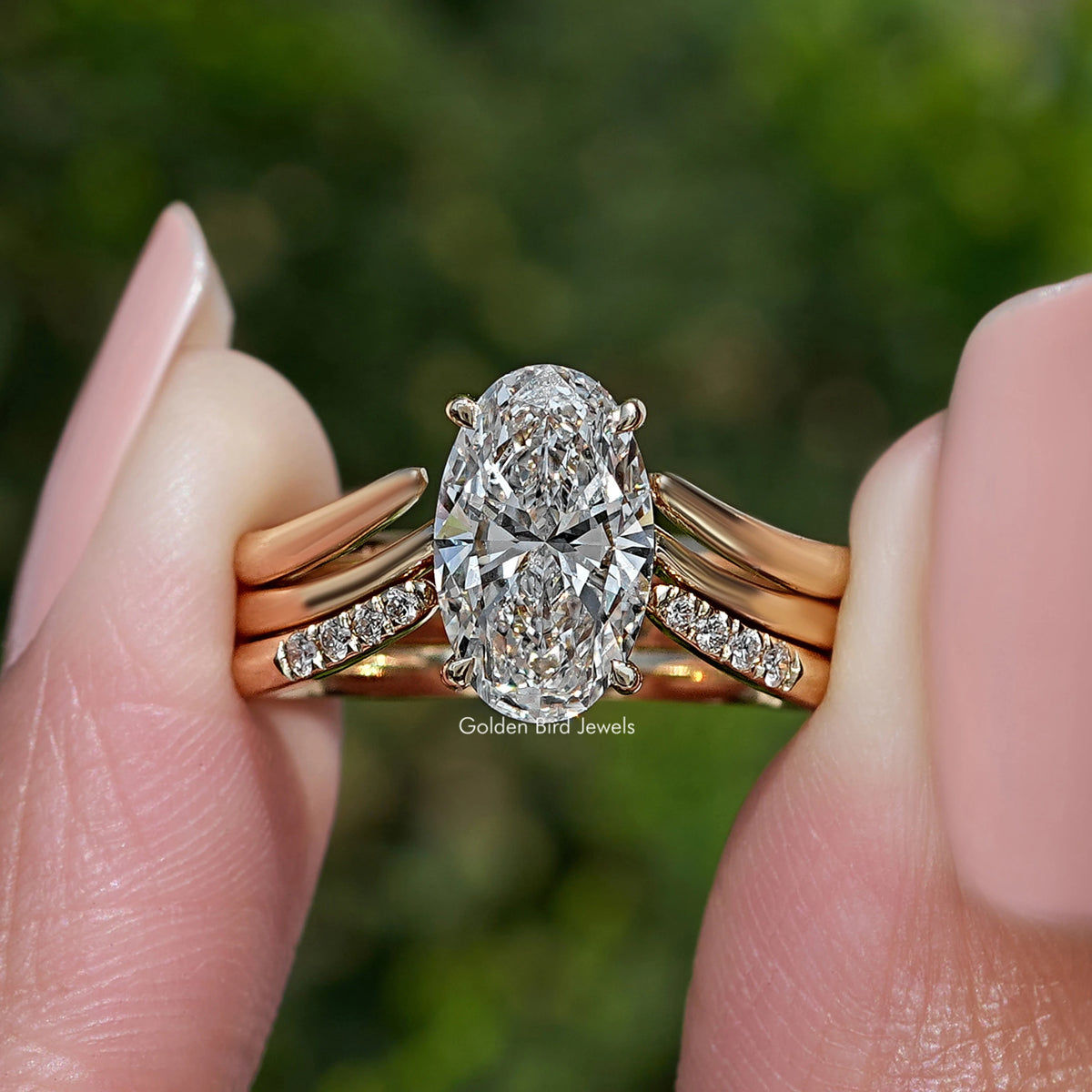Gold-tone bridal ring set with oval lab diamond and tapered side accents