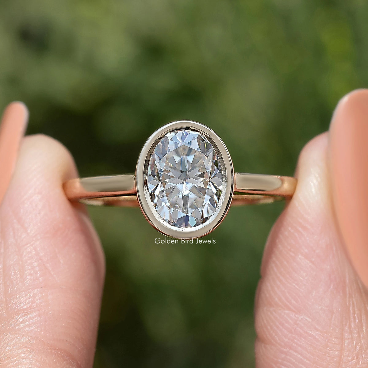 Oval moissanite solitaire ring with bezel-set round-oval stone and slim gold band