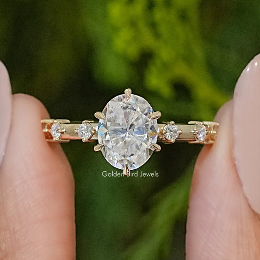 Oval-cut moissanite engagement ring with prong-set oval center and side stones