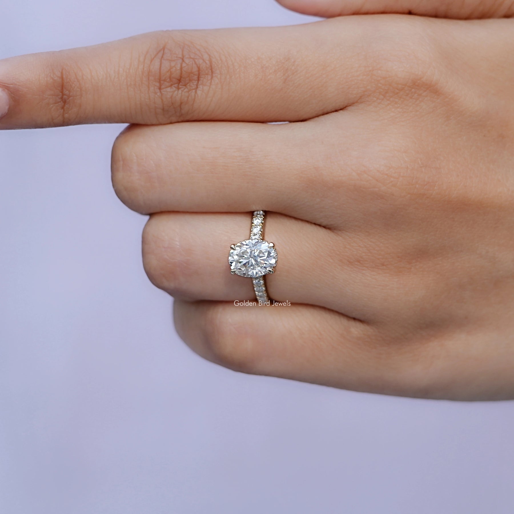 View of solitaire Oval Moissanite Bridge Cut Ring in prongs setting 