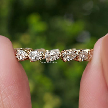 Row of lab-grown diamond pear-shaped stones on eternity band ring