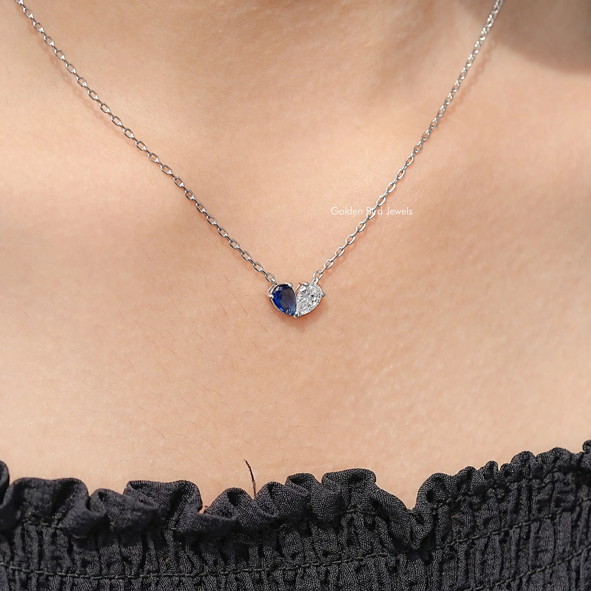 Sterling silver two-stone pendant necklace, pear-cut blue stone with clear accent