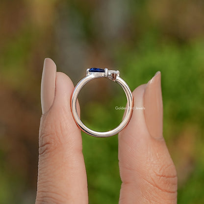 Sterling silver toi et moi ring showing round band and blue stone top view
