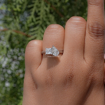 Toi et moi moissanite ring with pear and princess stones on a silver band