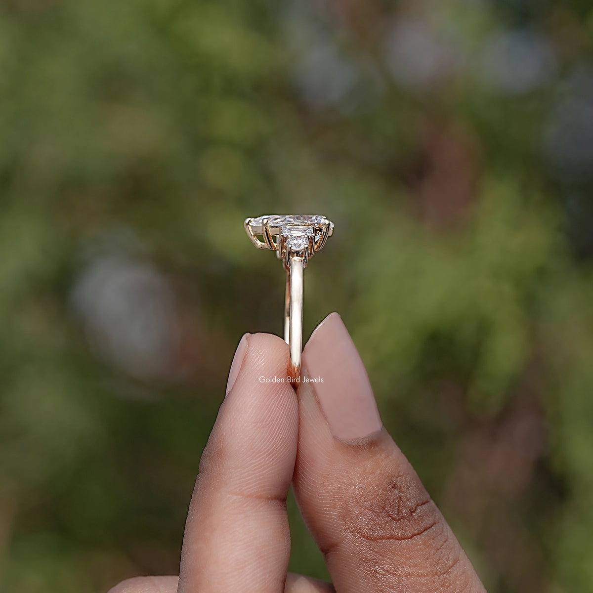 Side View of Pear And Baguette Cut Diamond Five Stone Ring
