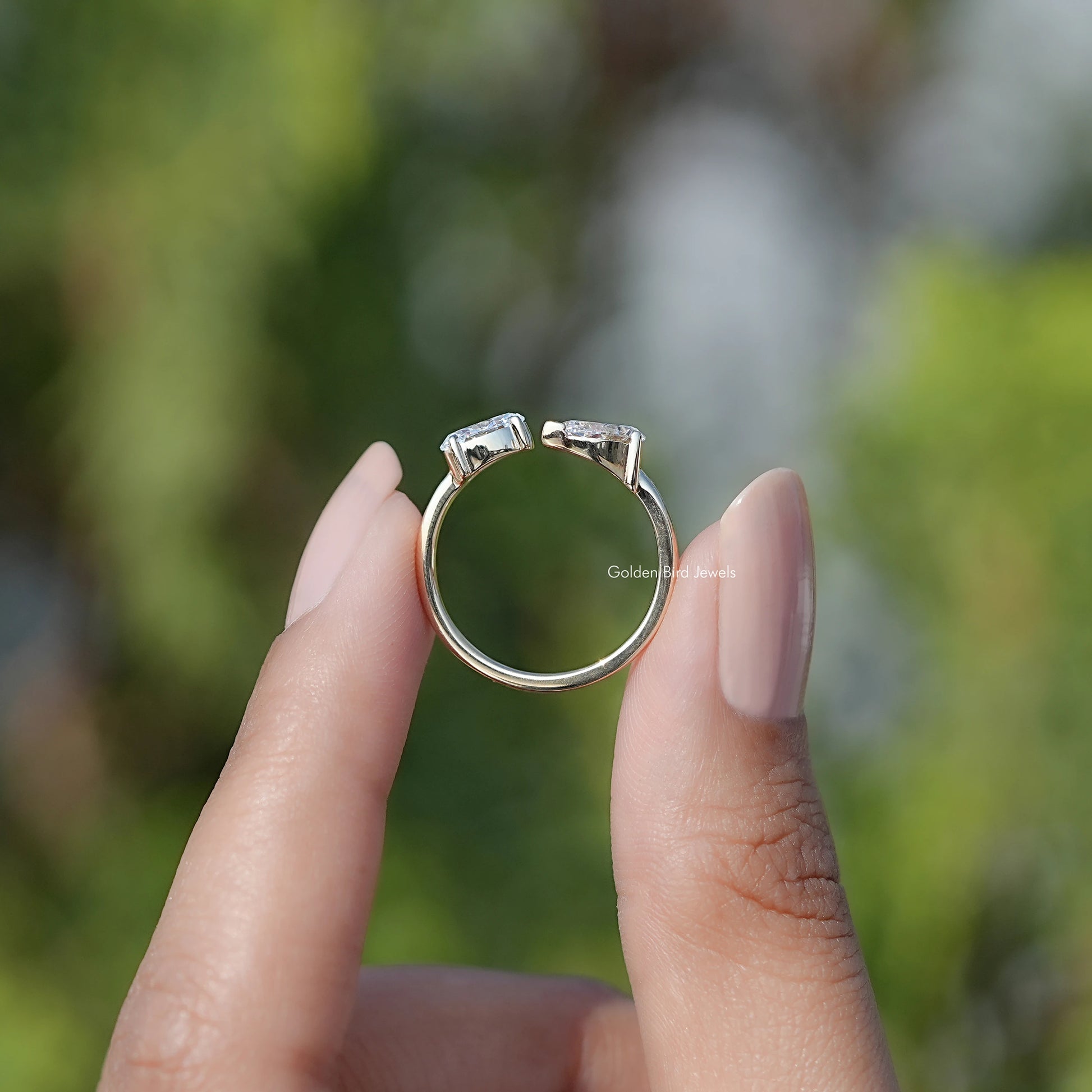Back view of Pear And Oval Shape Lab Diamond Halo Ring in secure setting 
