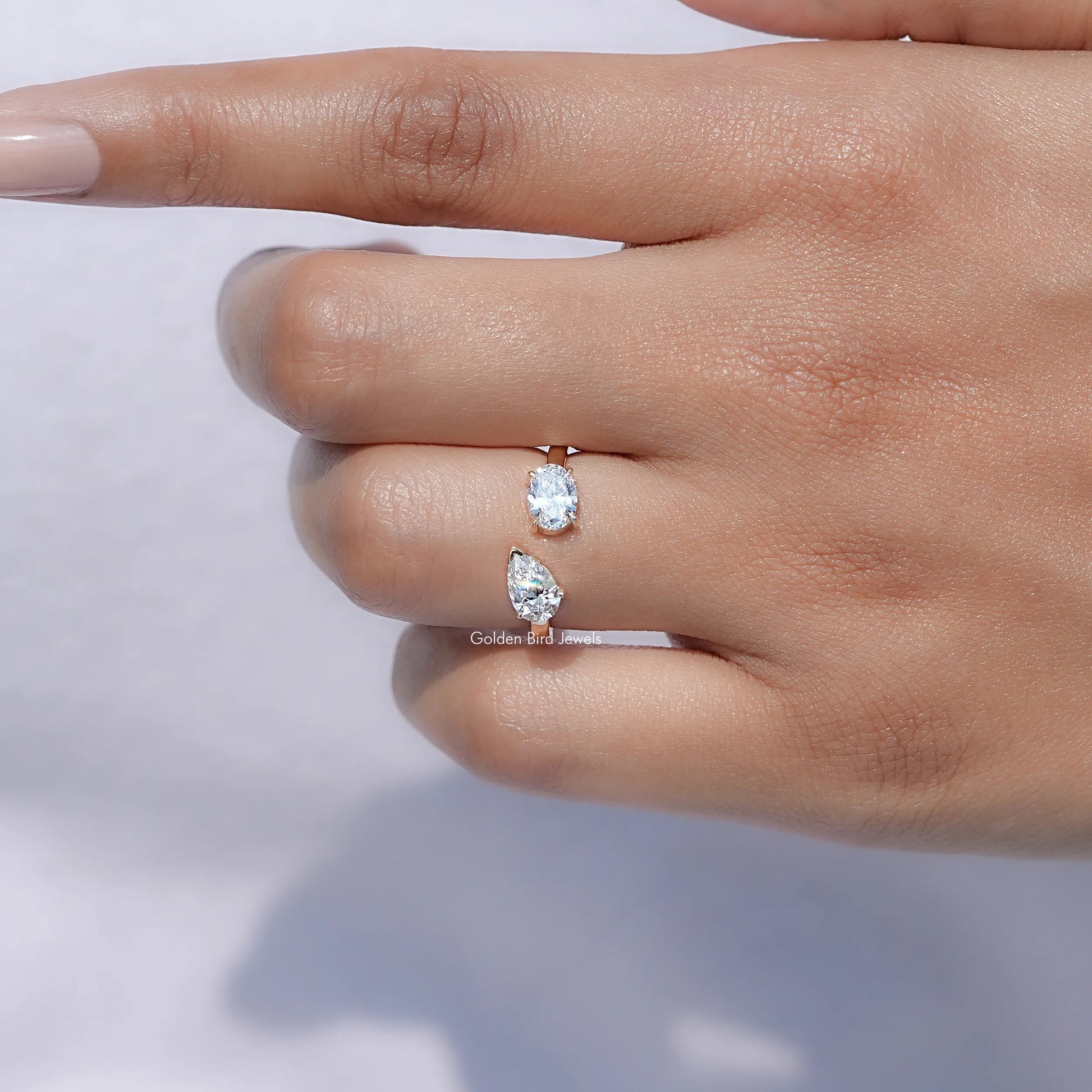 View of Pear And Oval Shape Lab Diamond Halo Ring in prongs setting 
