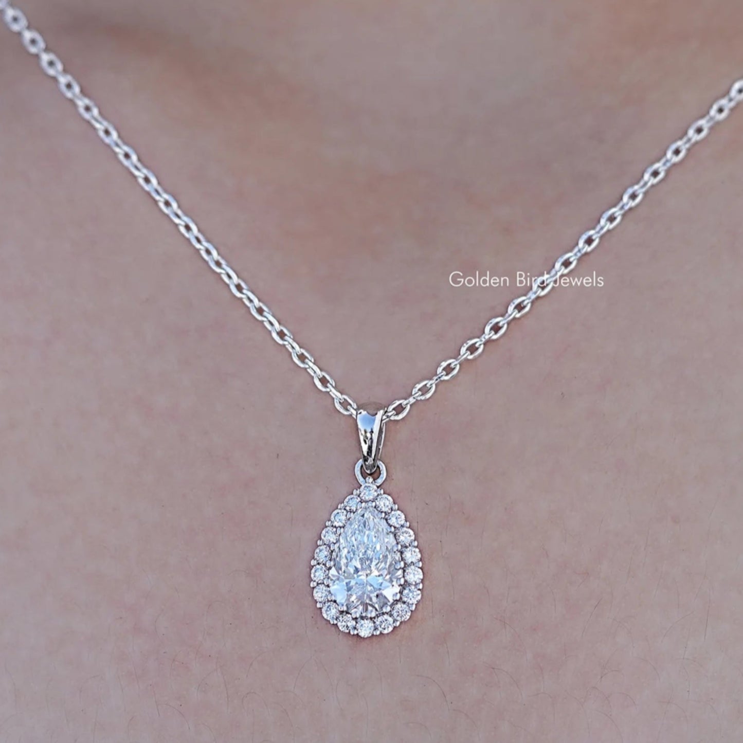 Close up view of Lab Grown Pear Cut Halo Pendant In White Gold